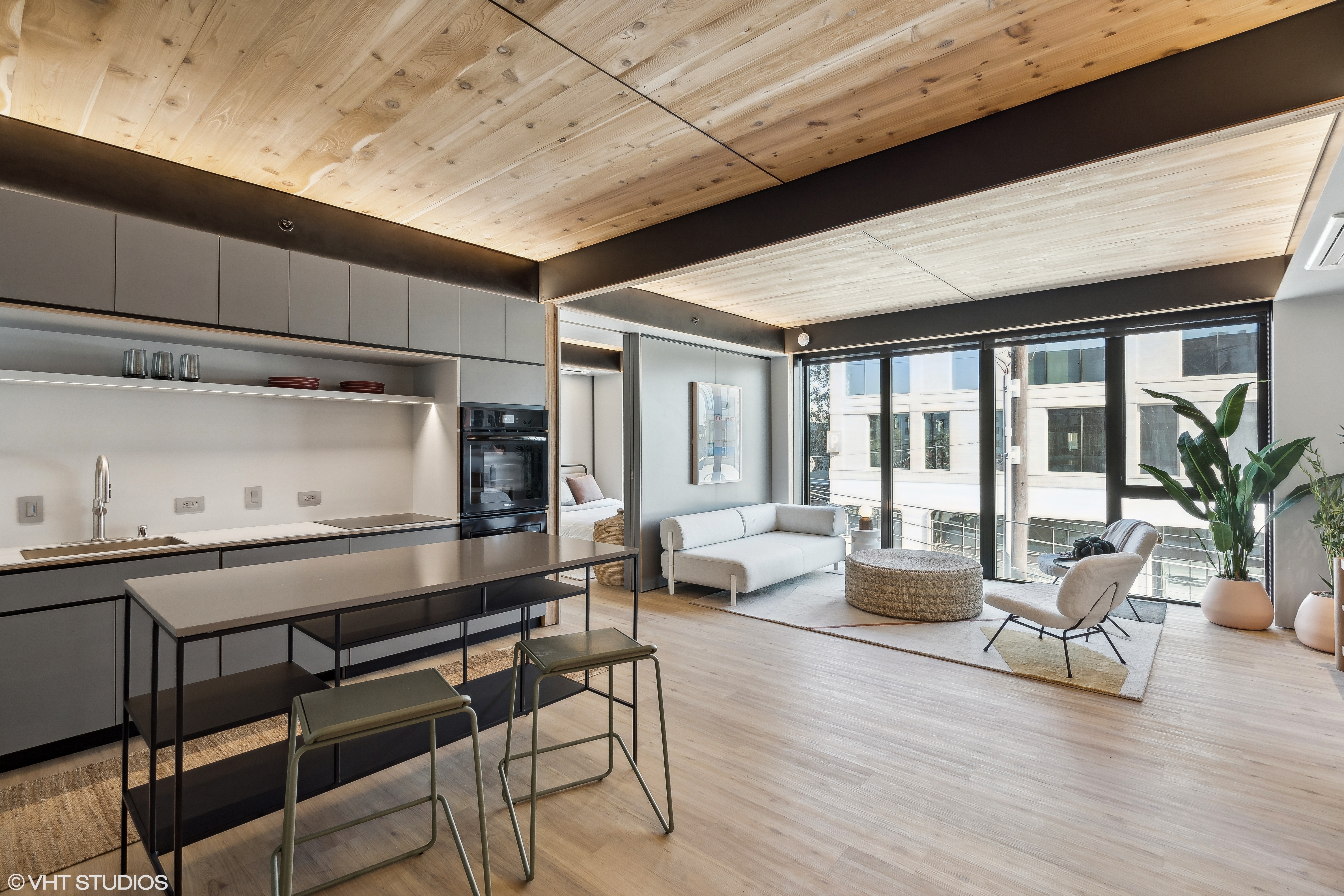 Open-plan kitchen and living room with a light island and sofa